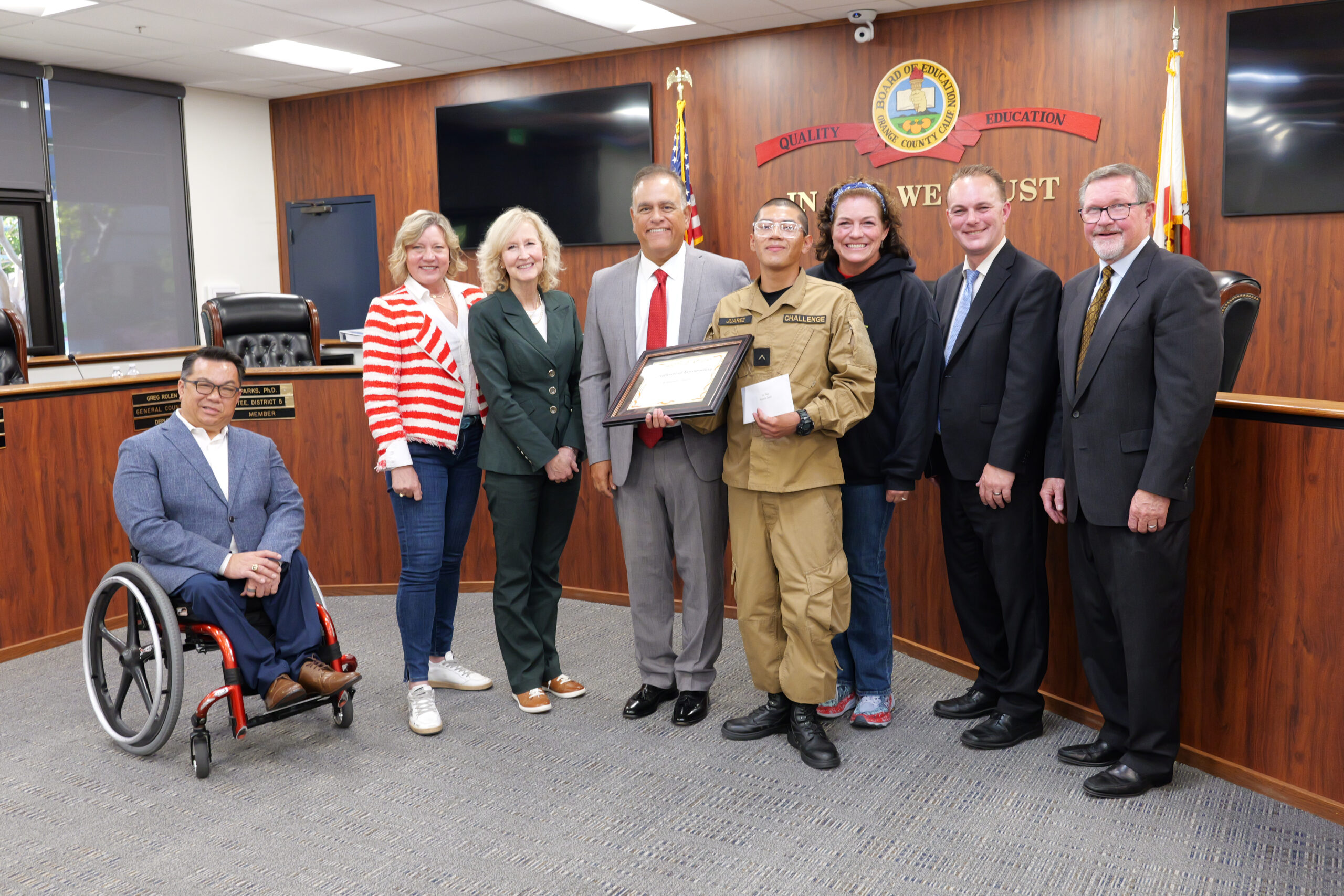 Cadet Juarez accepts his award alongside members of the Orange County Board of Education, Superintendent Dr. Stefan Bean, and his teacher, Elizabeth Wilson. 