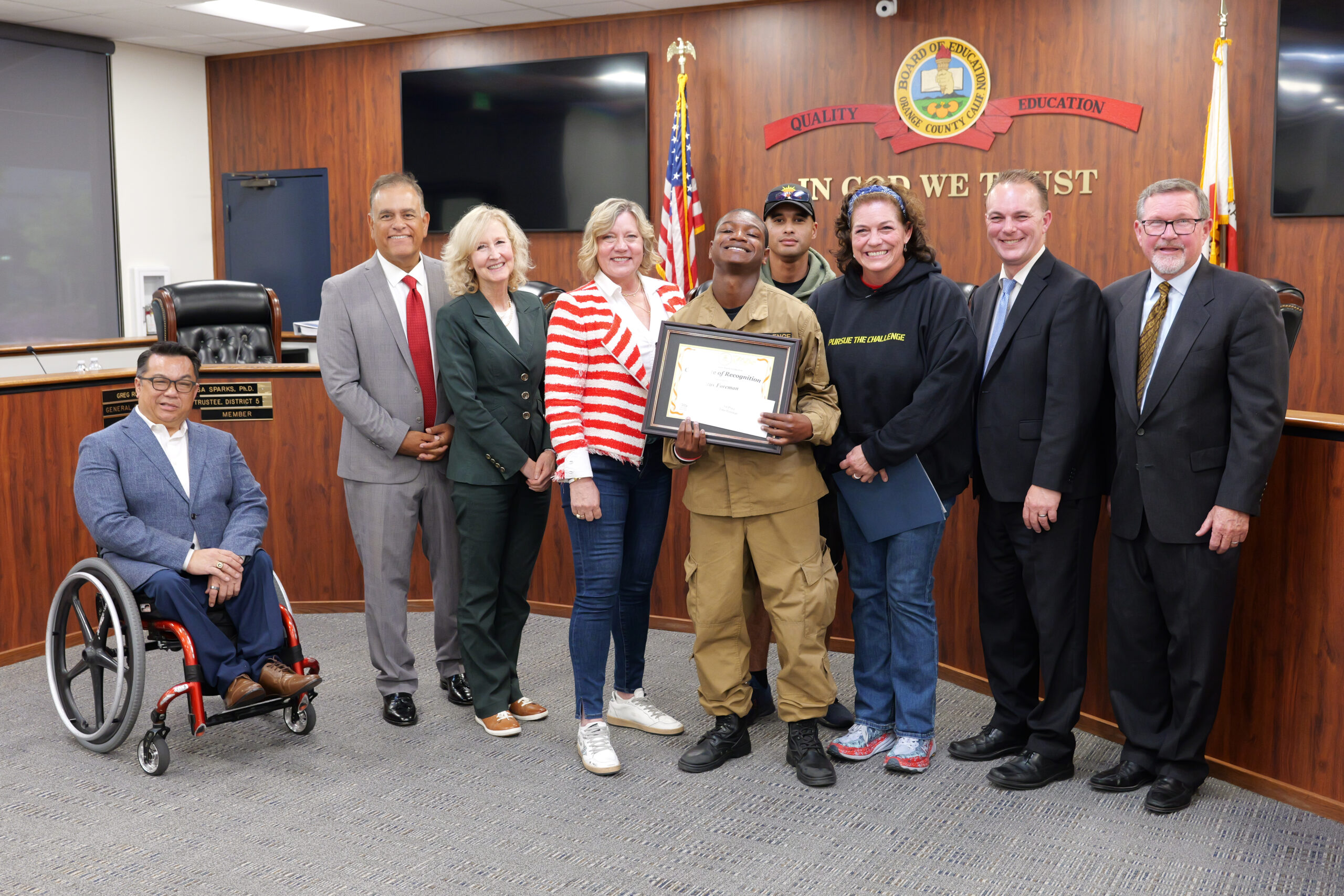 Cadet Foreman accepts his award alongside members of the Orange County Board of Education, Superintendent Dr. Stefan Bean, and his teacher, Elizabeth Wilson. 