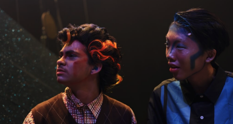 Aissa (left) and a fellow cast member performing in University High School's "Dreamland."