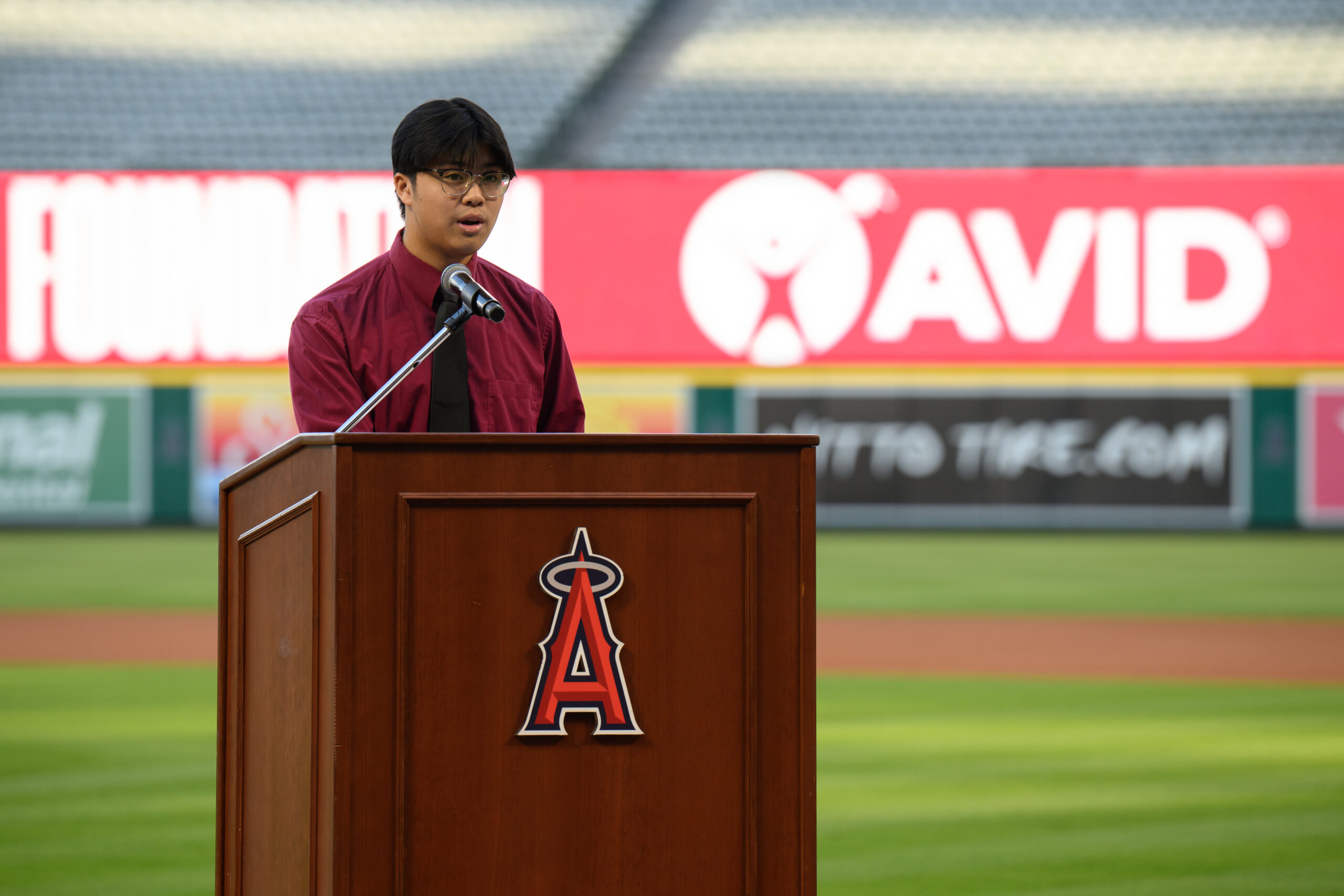 Joseph Bui, a 2022 Angels Scholar recipient and student at Bolsa Grande High School, speaks during the 2026 AVID 8th Grade Standout Recognition ceremony at Angel Stadium.