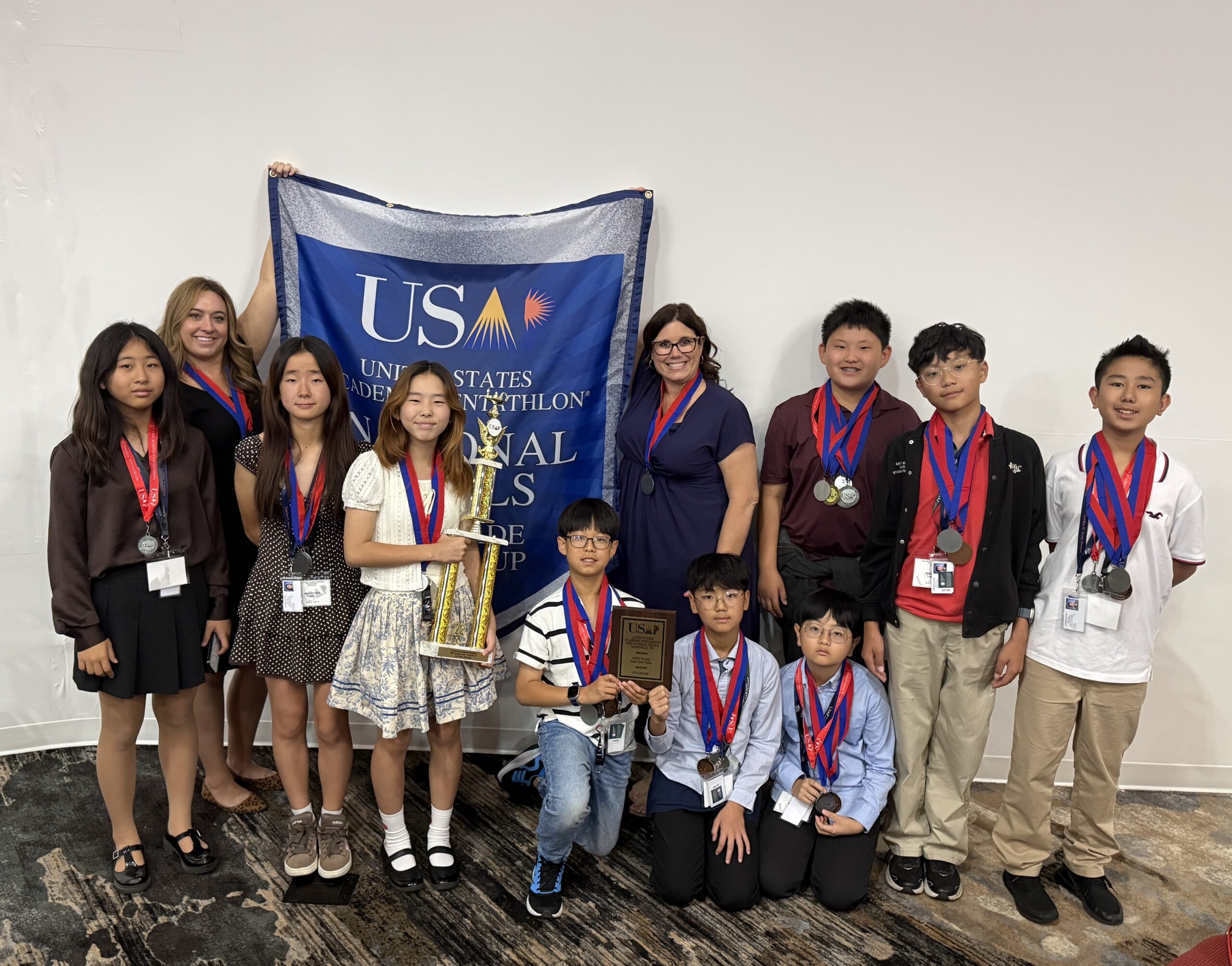 Students and coaches from Gordon H. Beatty Middle School pose with medals and awards earned at the 2026 United States Academic Pentathlon National Finals in Nashville, Tennessee.