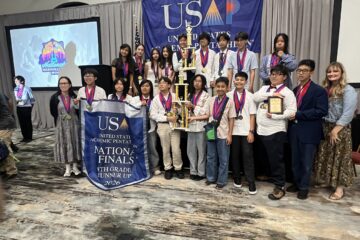 Students from McGarvin Intermediate School pose with medals and trophies during an awards ceremony at the 2026 United States Academic Pentathlon National Finals in Nashville, Tennessee.