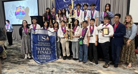Students from McGarvin Intermediate School pose with medals and trophies during an awards ceremony at the 2026 United States Academic Pentathlon National Finals in Nashville, Tennessee.
