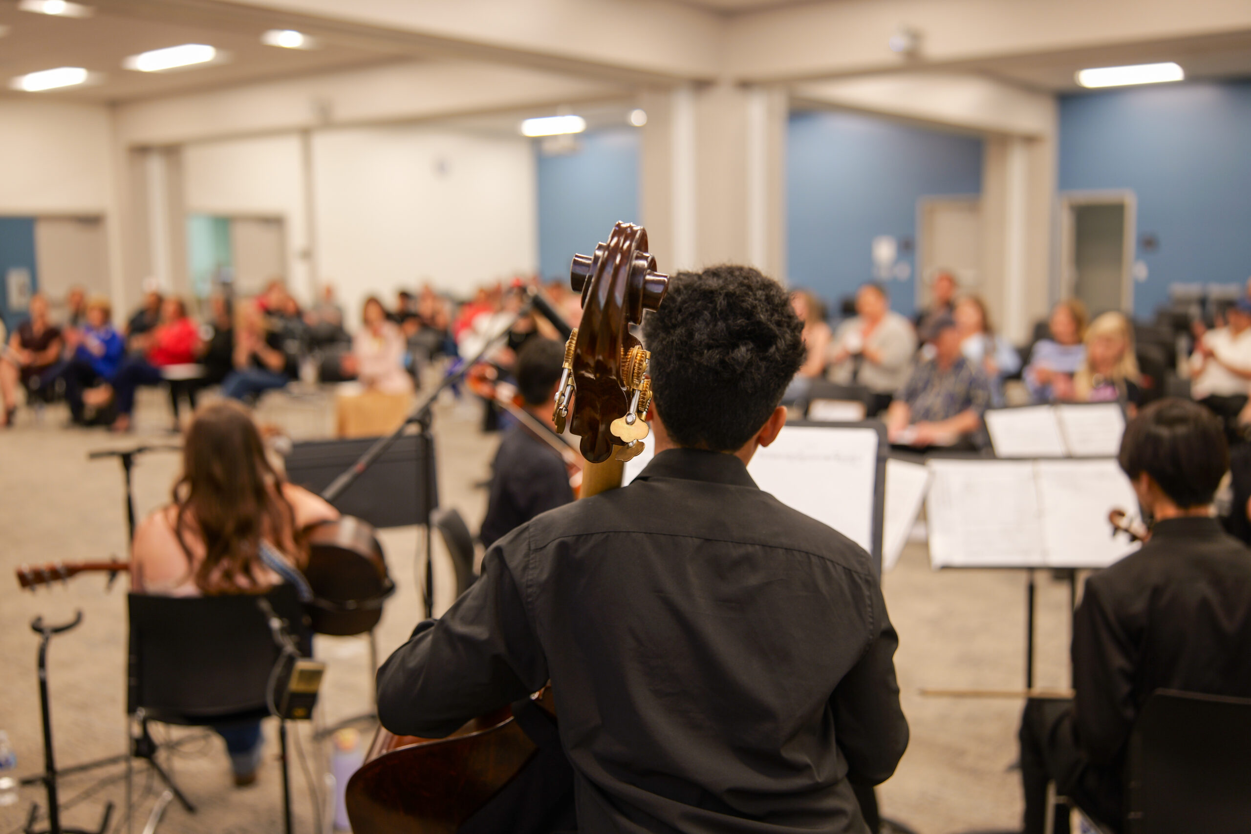 Student musicians perform for an audience during the USA 250-OC Theme Song Competition showcase.