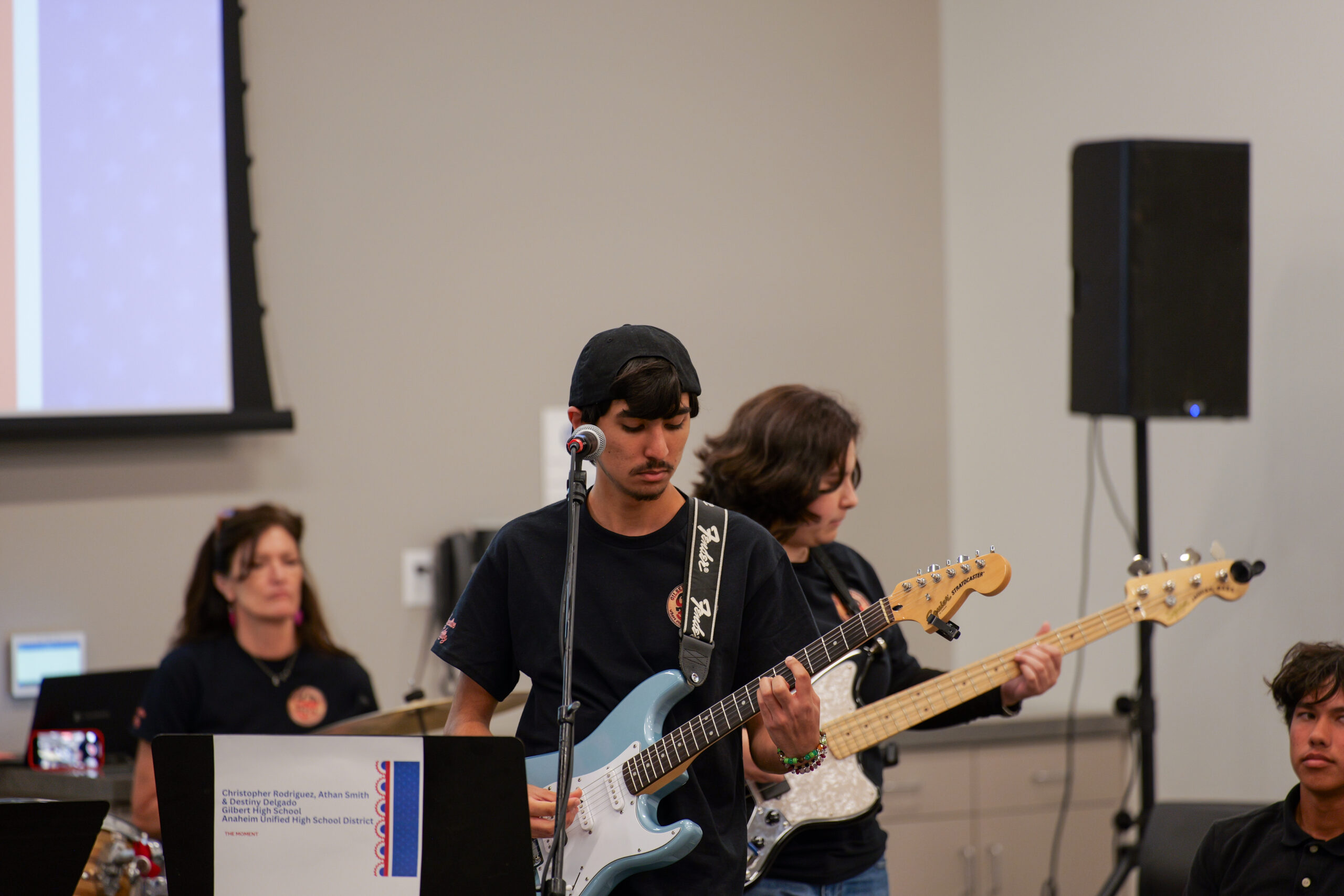 A student guitarist performs "The Moment," the winning rock song in the USA 250-OC Theme Song Competition, during the June 6 showcase.