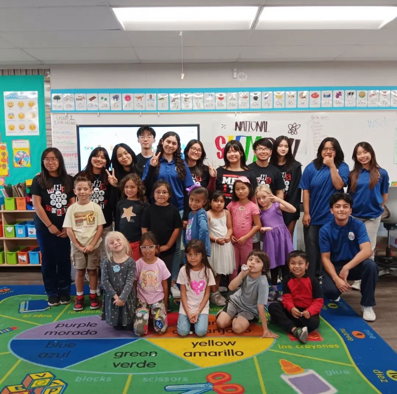 Student ambassador Sophia Le leads a STEM presentation to a group of elementary school students alongside her fellow Chief Science Officers.
