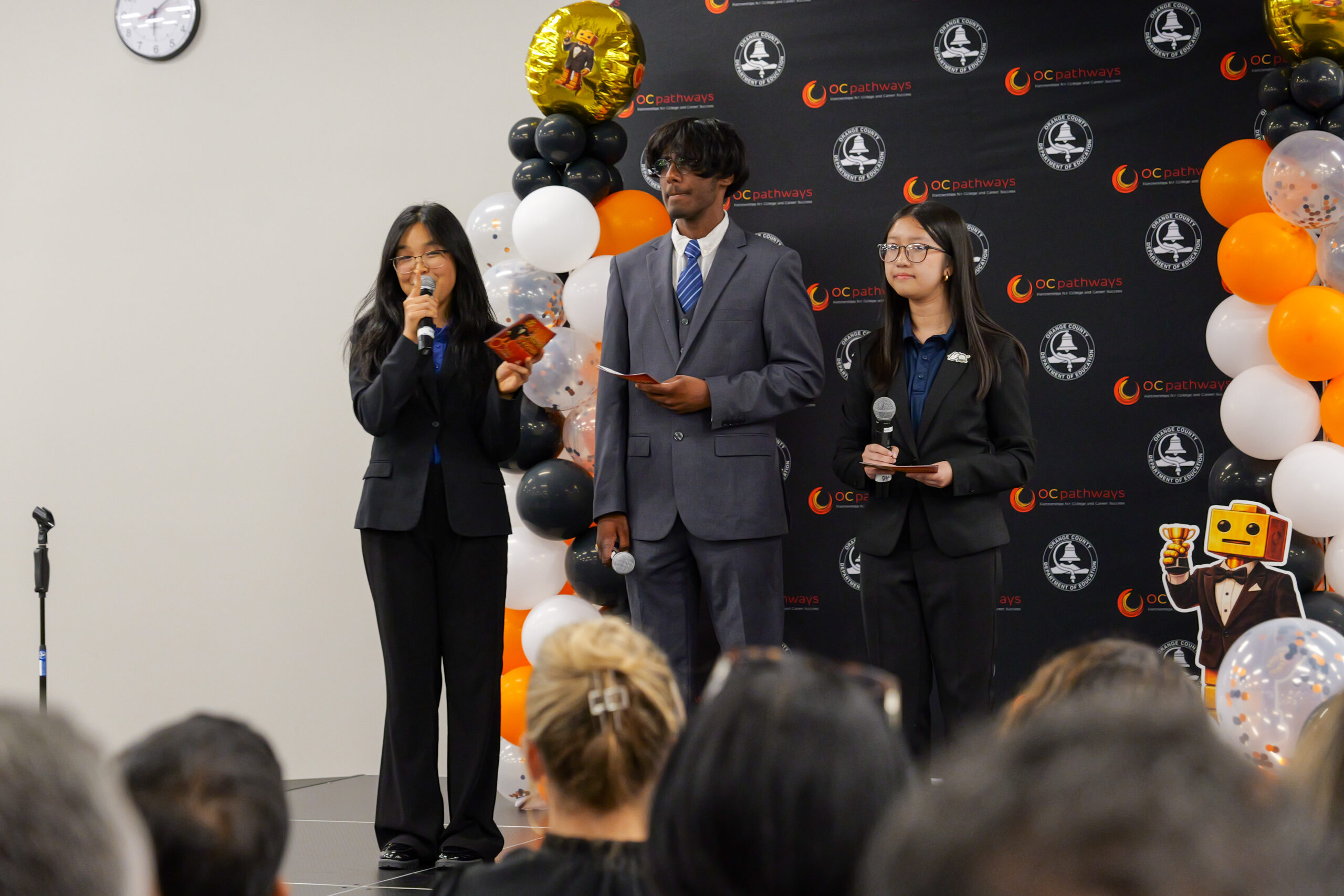 Sophia Le presents with a group of OC Pathways student ambassadors at the annual OC Maker Challenge in May.
