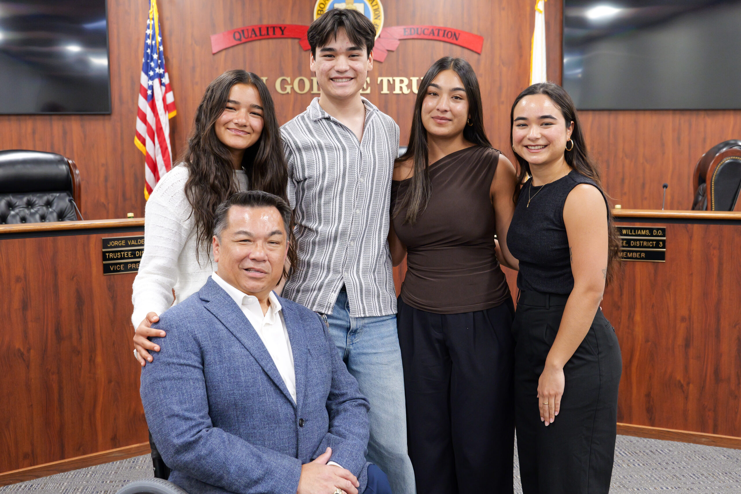 Dr. Stefan Bean poses for a photo with his four children after his swearing-in ceremony in the OCDE Board Room.