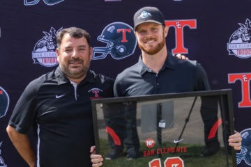Sam Darnold posing with his retired jersey alongside Head Coach Jaime Ortiz at the Triton Hall of Fame Golf Tournament at the Talega Golf Course in San Clemente.