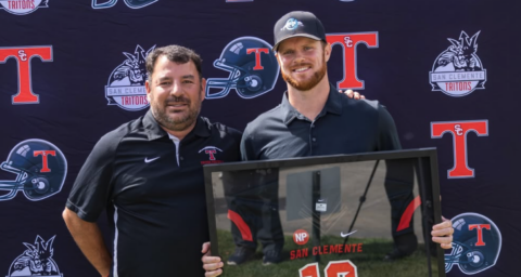 Sam Darnold posing with his retired jersey alongside Head Coach Jaime Ortiz at the Triton Hall of Fame Golf Tournament at the Talega Golf Course in San Clemente.