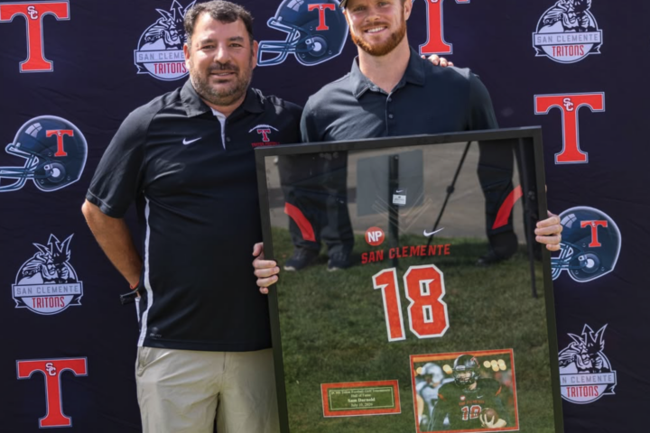 Sam Darnold posing with his retired jersey alongside Head Coach Jaime Ortiz at the Triton Hall of Fame Golf Tournament at the Talega Golf Course in San Clemente.