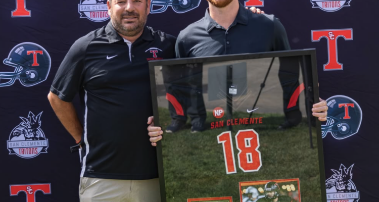 Sam Darnold posing with his retired jersey alongside Head Coach Jaime Ortiz at the Triton Hall of Fame Golf Tournament at the Talega Golf Course in San Clemente.