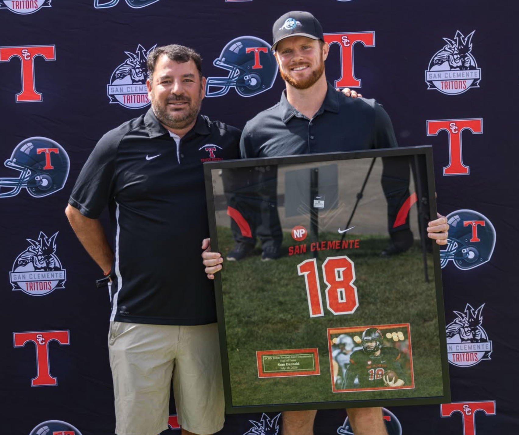 Sam Darnold posing with his retired jersey alongside Head Coach Jaime Ortiz at the Triton Hall of Fame Golf Tournament at the Talega Golf Course in San Clemente.