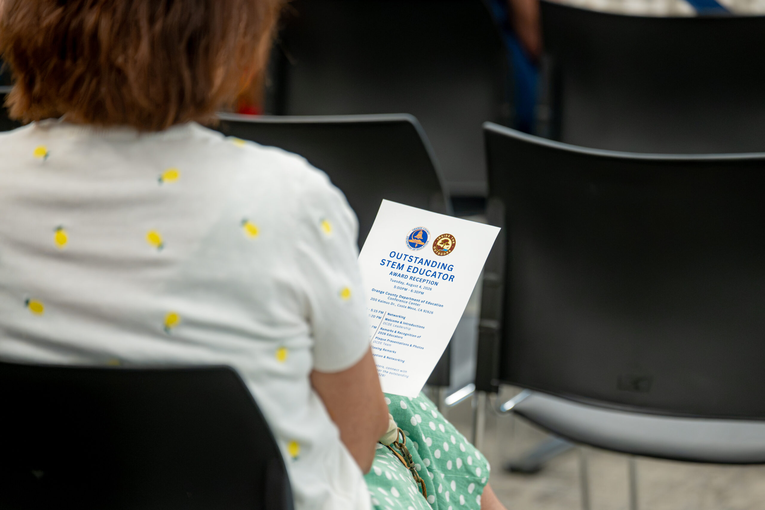 An attendee reviews the program for the 2026 Outstanding STEM Educator Awards Celebration, held Aug. 4 at the Orange County Department of Education Conference Center in Costa Mesa.