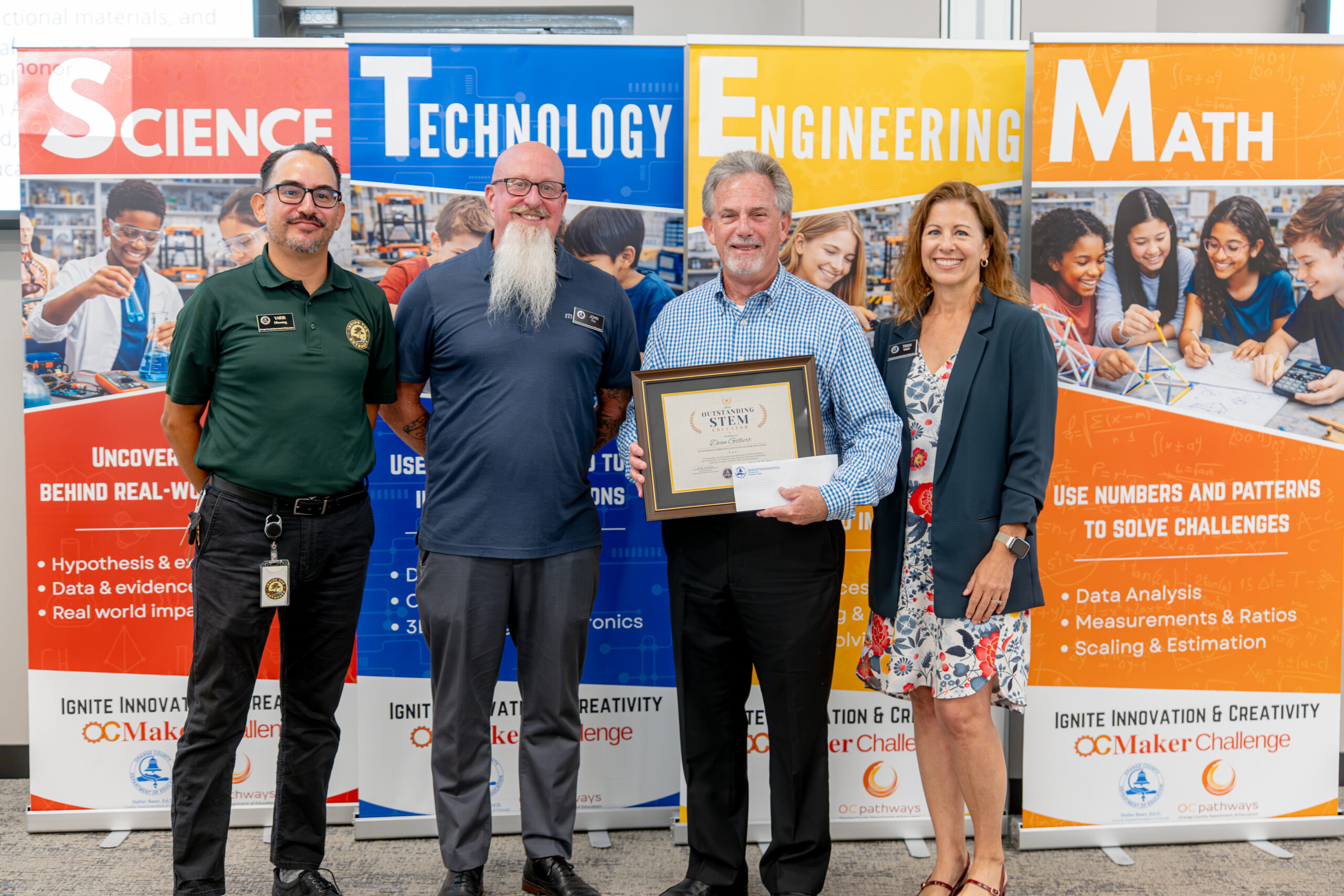 Dean Gilbert of the Orange County Science & Engineering Fair receives an Outstanding Community Advocate in STEM Education Award.