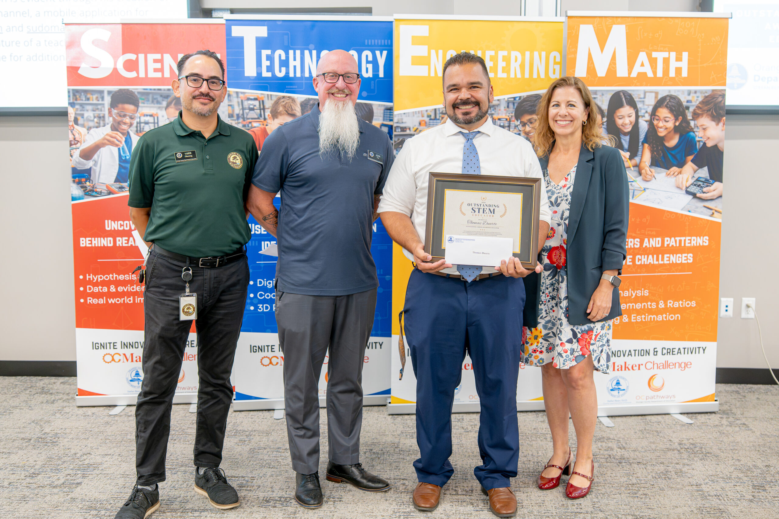 Thomas Duarte of Anaheim High School, center, receives an Outstanding Career Awareness Educator Award alongside OCDE and Inside the Outdoors staff.