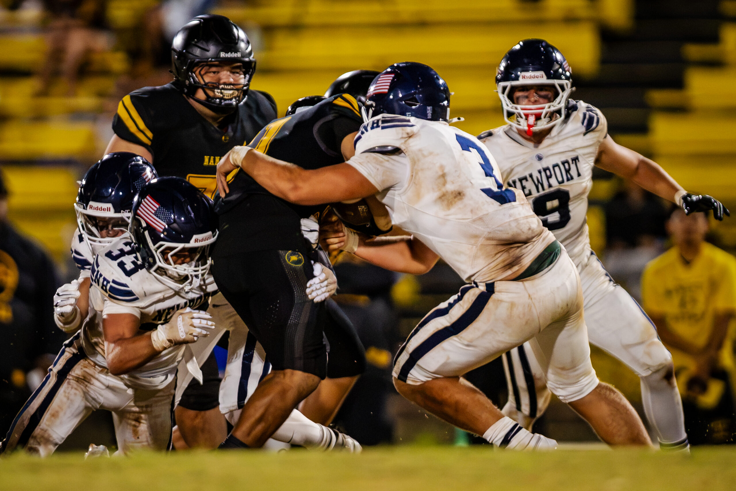 Newport linebackers Jett Blauwkamp (No. 3) and Cameron Hatfield (No. 33) combine for a tackle against Nanakuli in their opening game in Oahu.