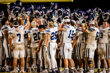 Newport Harbor huddles up after beating Nanakuli 41-0 in their opening game in Oahu.