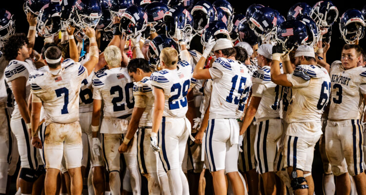 Newport Harbor huddles up after beating Nanakuli 41-0 in their opening game in Oahu.