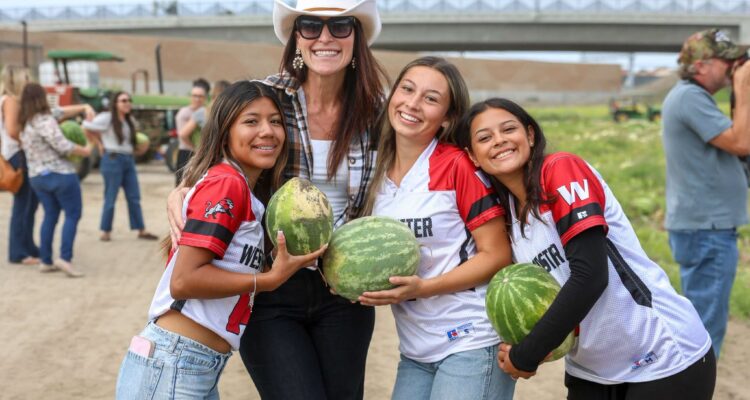 Westminster High School Principal Amy Sabol joins students during the Giving Farm’s annual watermelon harvest.