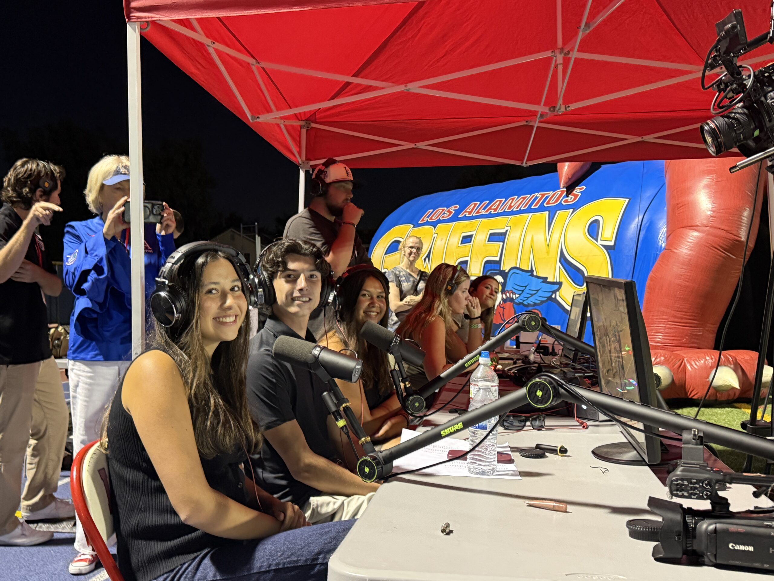 Los Alamitos High School students work behind the microphones during the school’s first student-produced live varsity football broadcast on Sept. 4.
