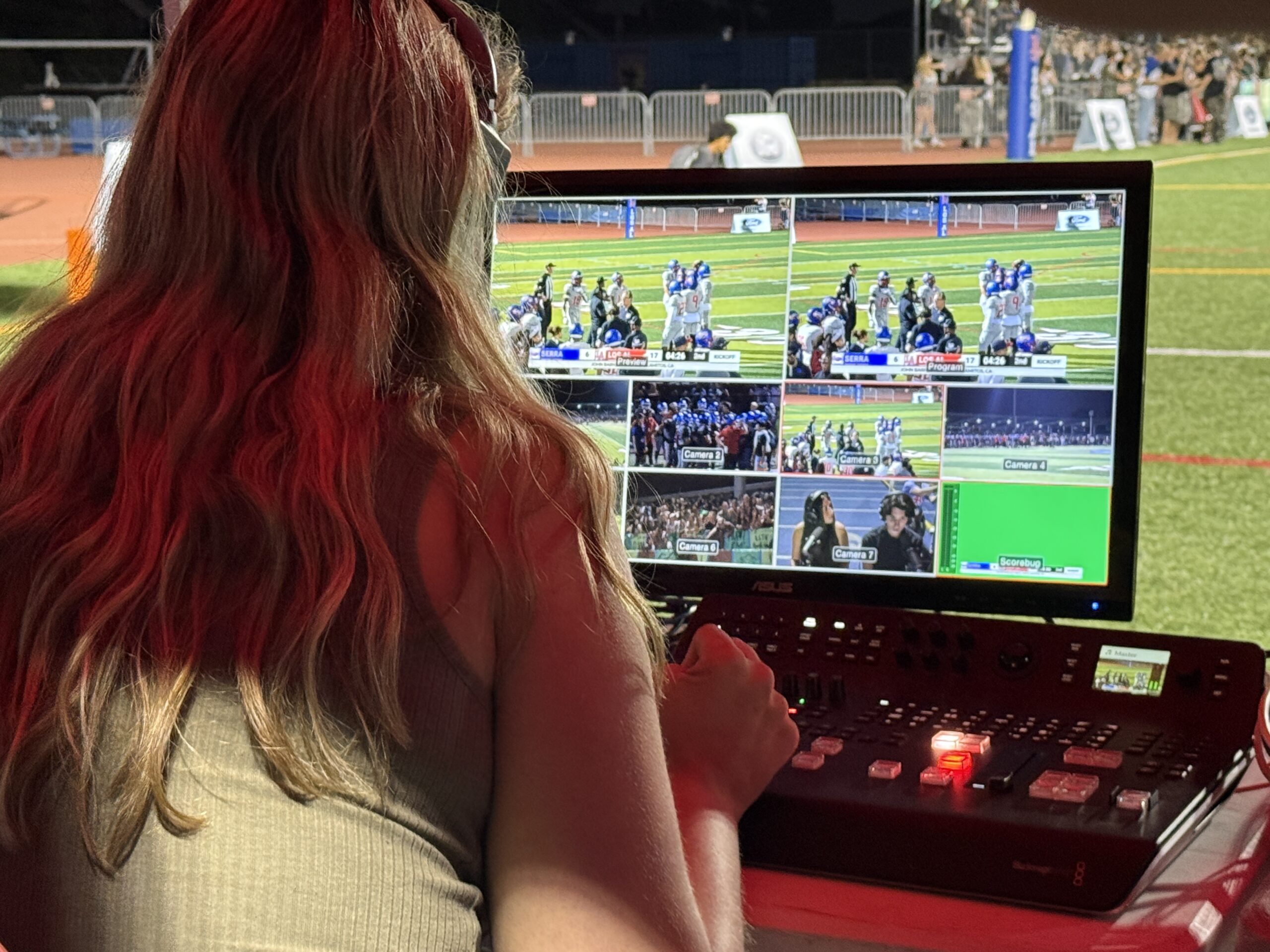 A Los Alamitos High School student monitors multiple camera feeds while helping produce the Griffins’ Sept. 4 varsity football game against Junipero Serra High School.