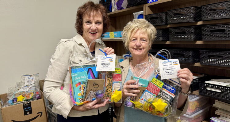 OCDE Student Programs and Services Coordinator Jeanne Awrey, left, and Senior Administrative Assistant Terri Glover hold welcome gifts prepared for children and youth staying in local homeless shelters. The gifts include school supplies, books and other items selected for students of different ages.