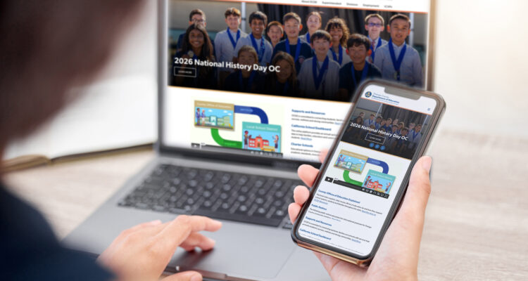 Person viewing OCDE’s redesigned website on a laptop and smartphone, showing the site’s responsive layout across desktop and mobile devices.