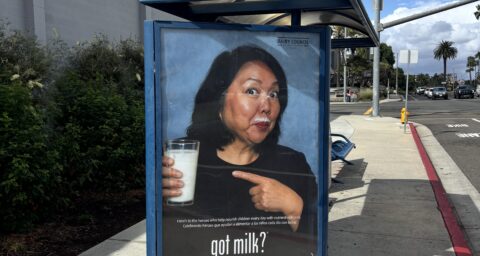 Huntington Beach Union High School District Superintendent Dr. Carolee Ogata appears in a Got Milk? advertisement displayed at a bus stop near Huntington Beach High School. The campaign recognizes school employees who help provide students with nutritious meals and beverages.