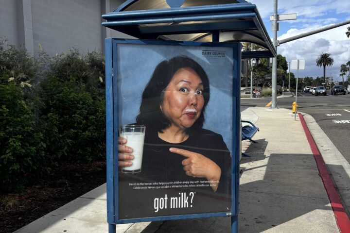 Huntington Beach Union High School District Superintendent Dr. Carolee Ogata appears in a Got Milk? advertisement displayed at a bus stop near Huntington Beach High School. The campaign recognizes school employees who help provide students with nutritious meals and beverages.