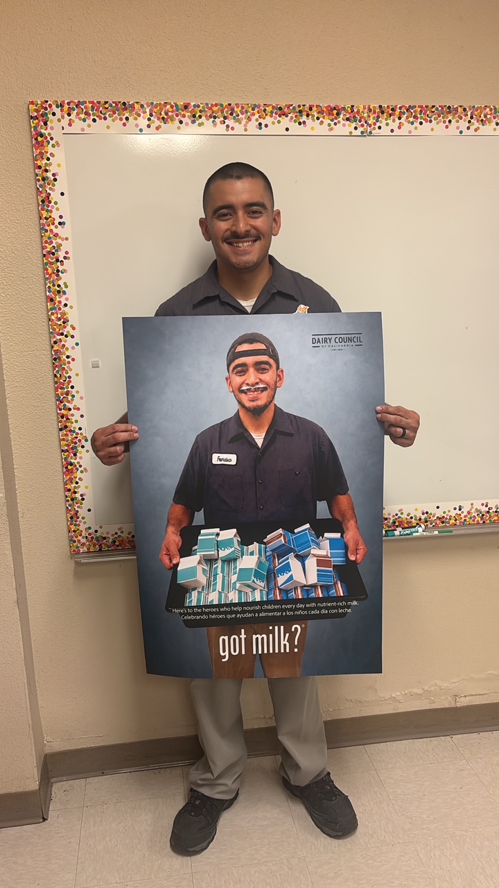 Frankie Ramos, a driver with Huntington Beach Union High School District's Nutrition Services team, holds his Got Milk? campaign poster. Ramos is one of five district employees featured in the campaign celebrating the people behind school nutrition.