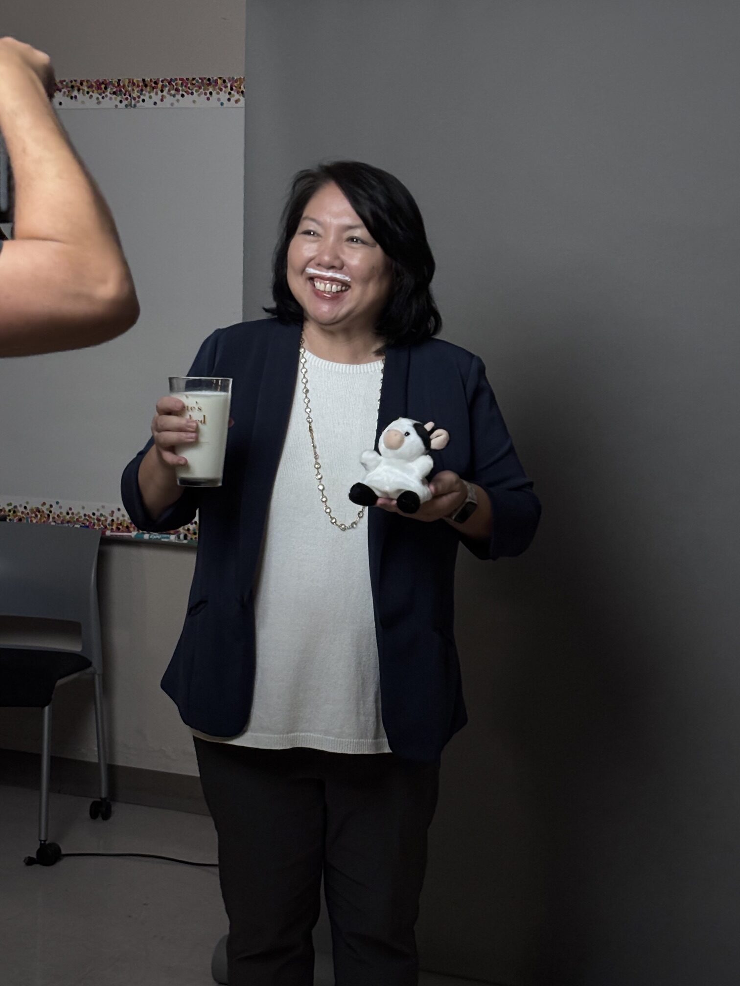 Huntington Beach Union High School District Superintendent Dr. Carolee Ogata poses with a glass of milk and a stuffed cow during a photo shoot for the Got Milk? campaign, which features five district employees.