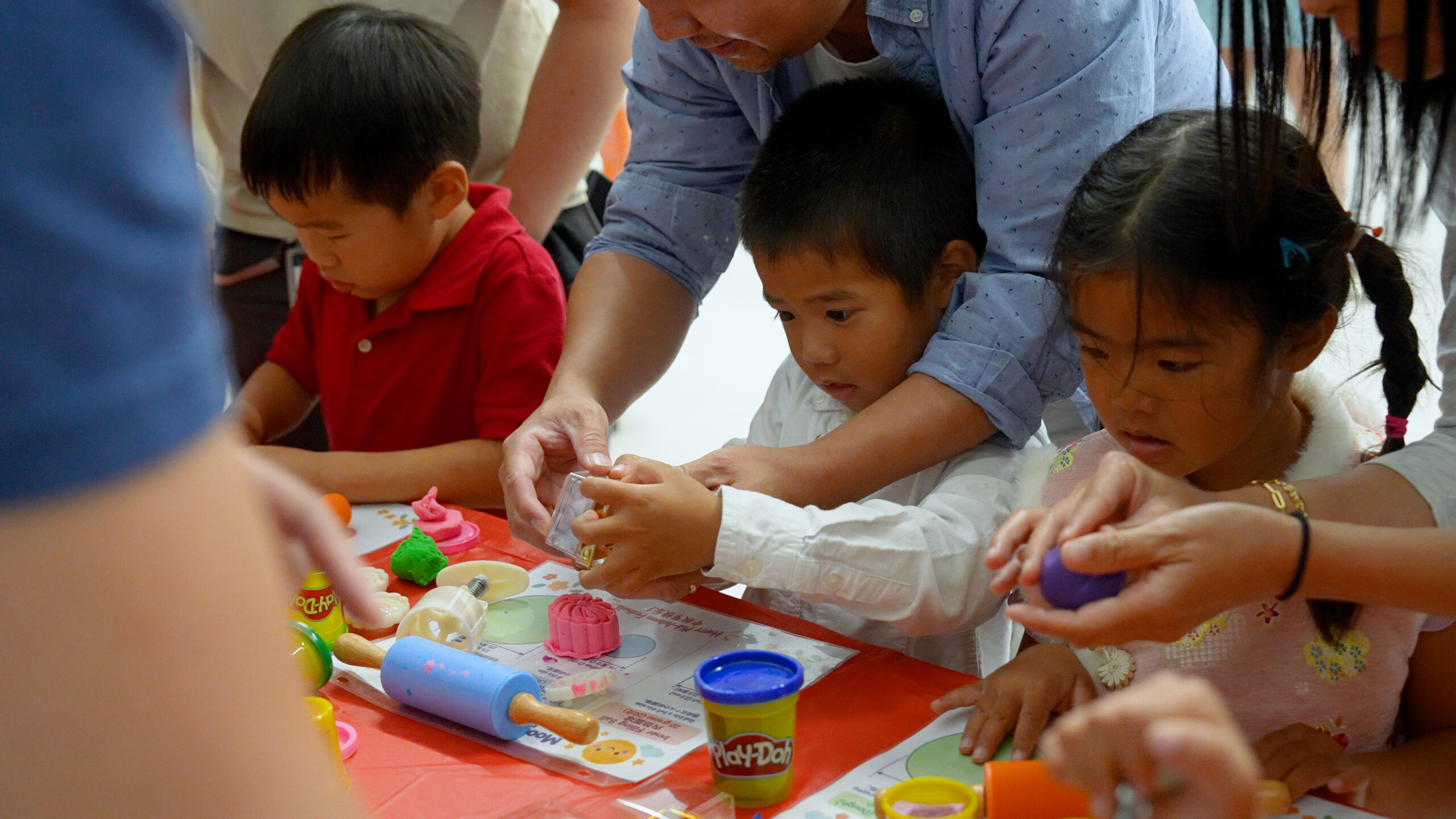 Children create colorful Play-Doh designs with help from adults during Hicks Canyon Elementary School's Mid-Autumn Festival celebration, which introduced families to Chinese cultural traditions through hands-on activities. (Photo courtesy of the Tustin Unified School District)