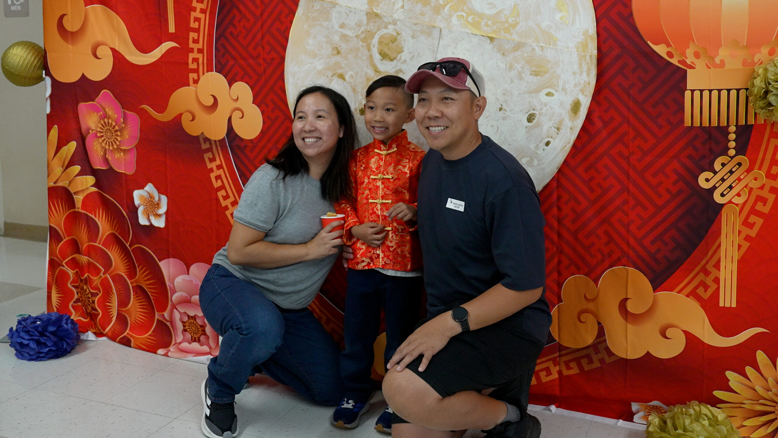 A student poses with family members in front of a moon-themed display during the Mid-Autumn Festival celebration at Hicks Canyon Elementary School. (Photo courtesy of the Tustin Unified School District)
