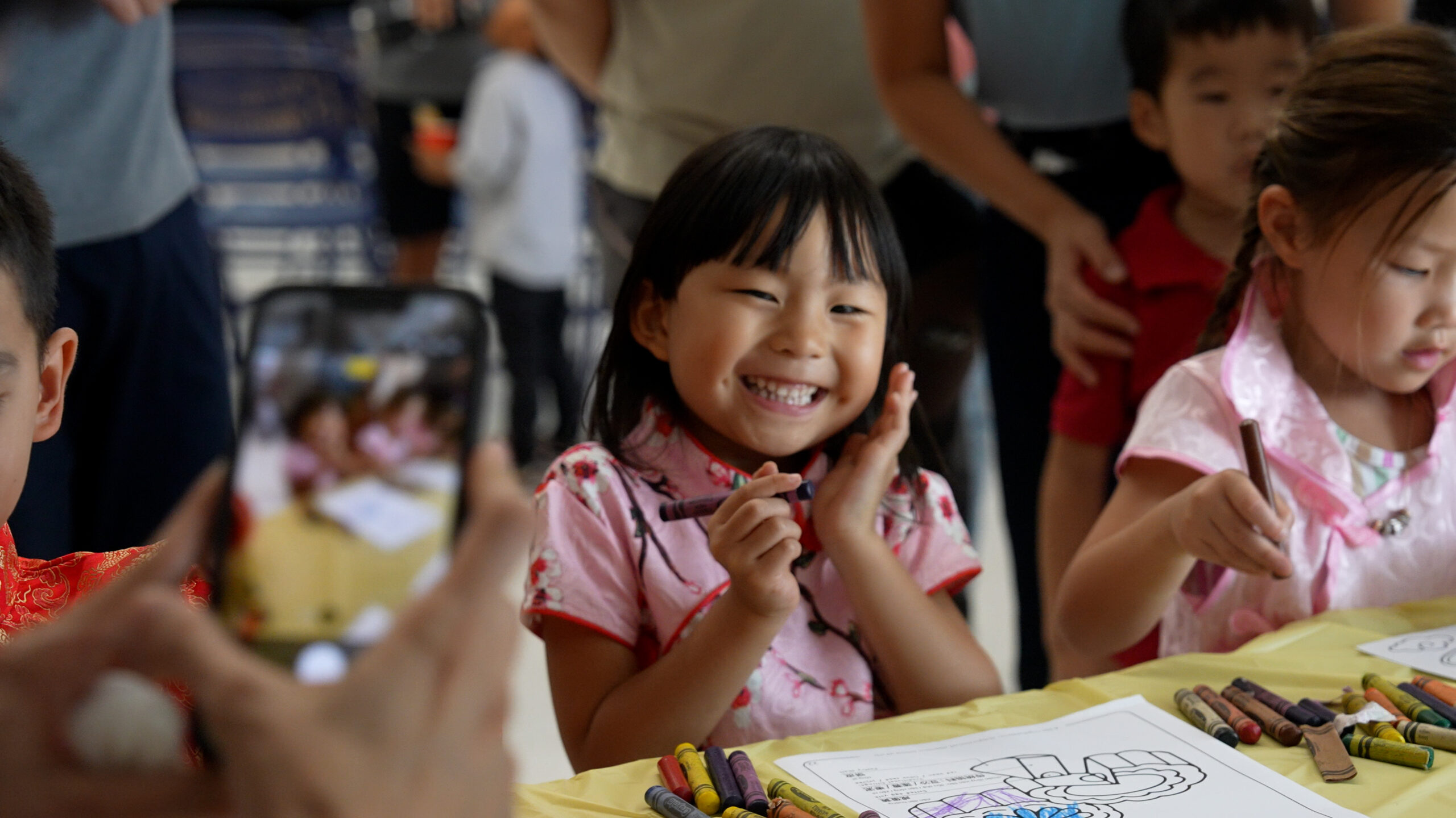 A young student smiles while participating in a coloring activity during Hicks Canyon Elementary School's Mid-Autumn Festival celebration, which brought students and families together to explore Chinese traditions. (Photo courtesy of the Tustin Unified School District)
