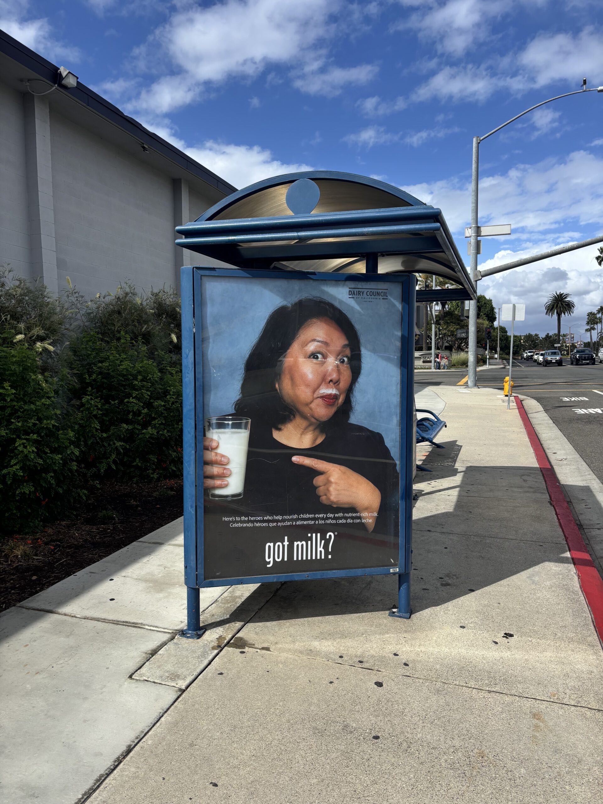 Huntington Beach Union High School District Superintendent Dr. Carolee Ogata appears in a Got Milk? advertisement displayed at a bus stop near Huntington Beach High School. The campaign recognizes school employees who help provide students with nutritious meals and beverages.