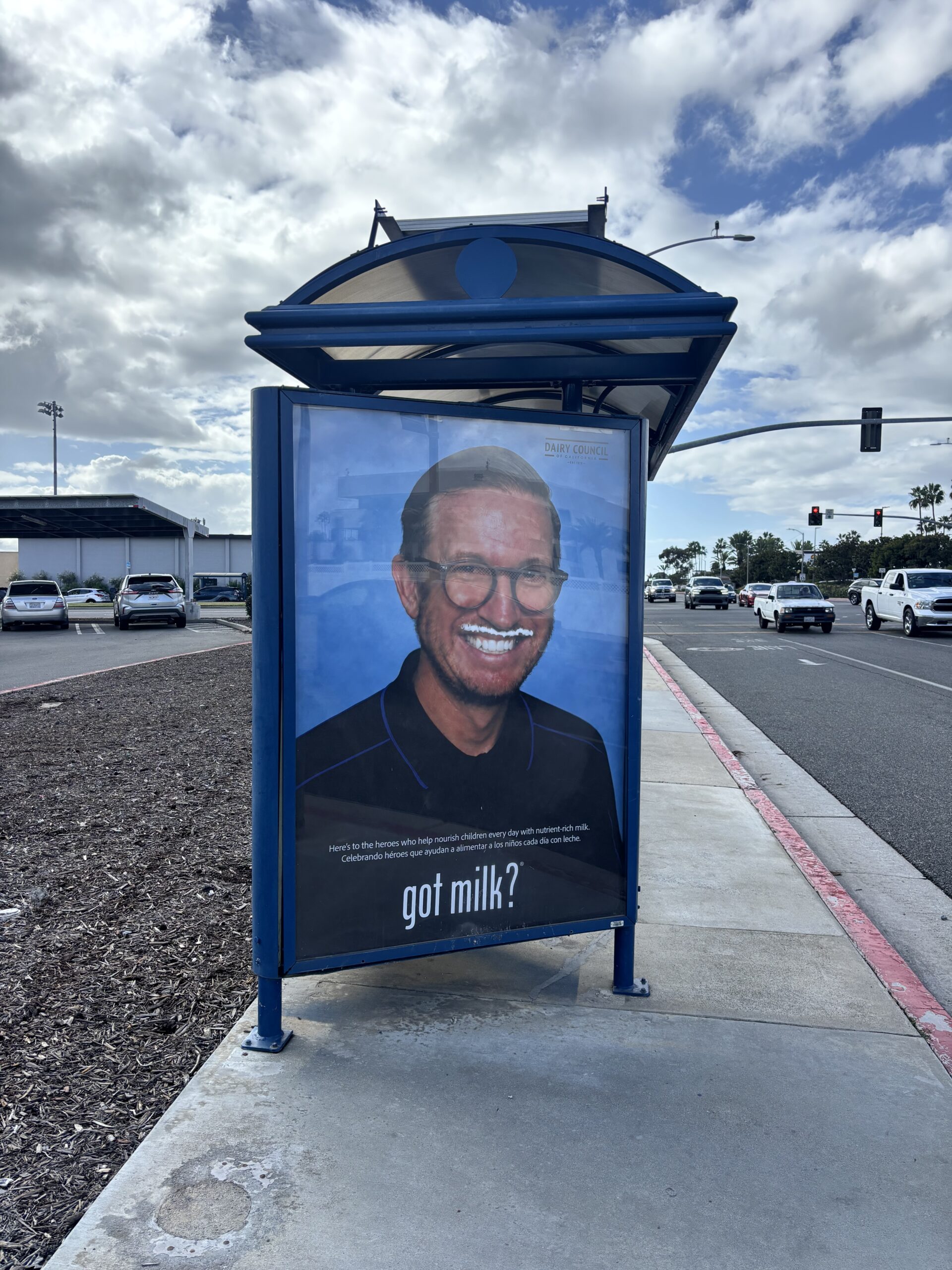 Patrick Ryan, a kitchen manager with Huntington Beach Union High School District, sports the iconic milk mustache in a Got Milk? bus stop advertisement. The campaign celebrates school nutrition employees and their contributions to student well-being.