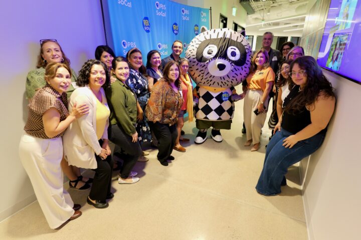 Attendees pose with Carl the Collector and OCDE Language Services Coordinator Natalia Abarca, in orange, during the department’s International Translation Day celebration at PBS SoCal studios in Costa Mesa.