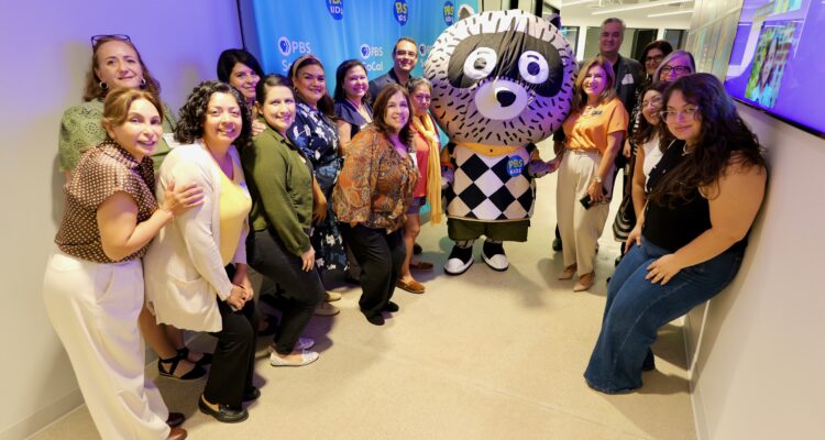 Attendees pose with Carl the Collector and OCDE Language Services Coordinator Natalia Abarca, in orange, during the department’s International Translation Day celebration at PBS SoCal studios in Costa Mesa.