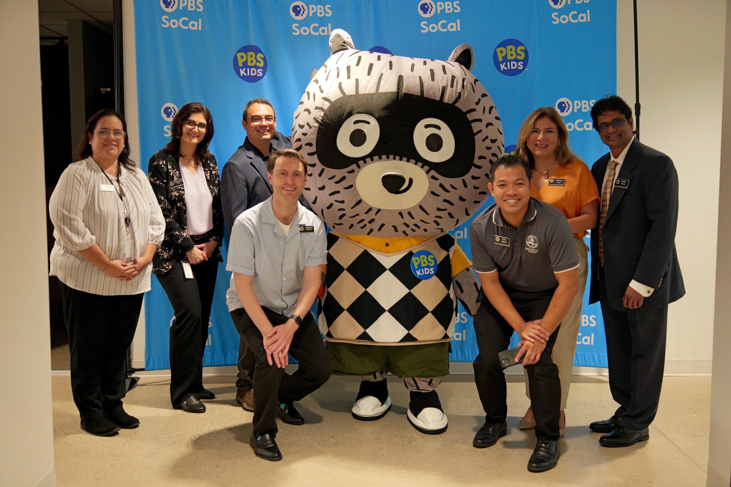 Members of OCDE’s Language Services and Educator Events and Partnerships teams pose with Carl the Collector during the International Translation Day celebration at PBS SoCal studios.