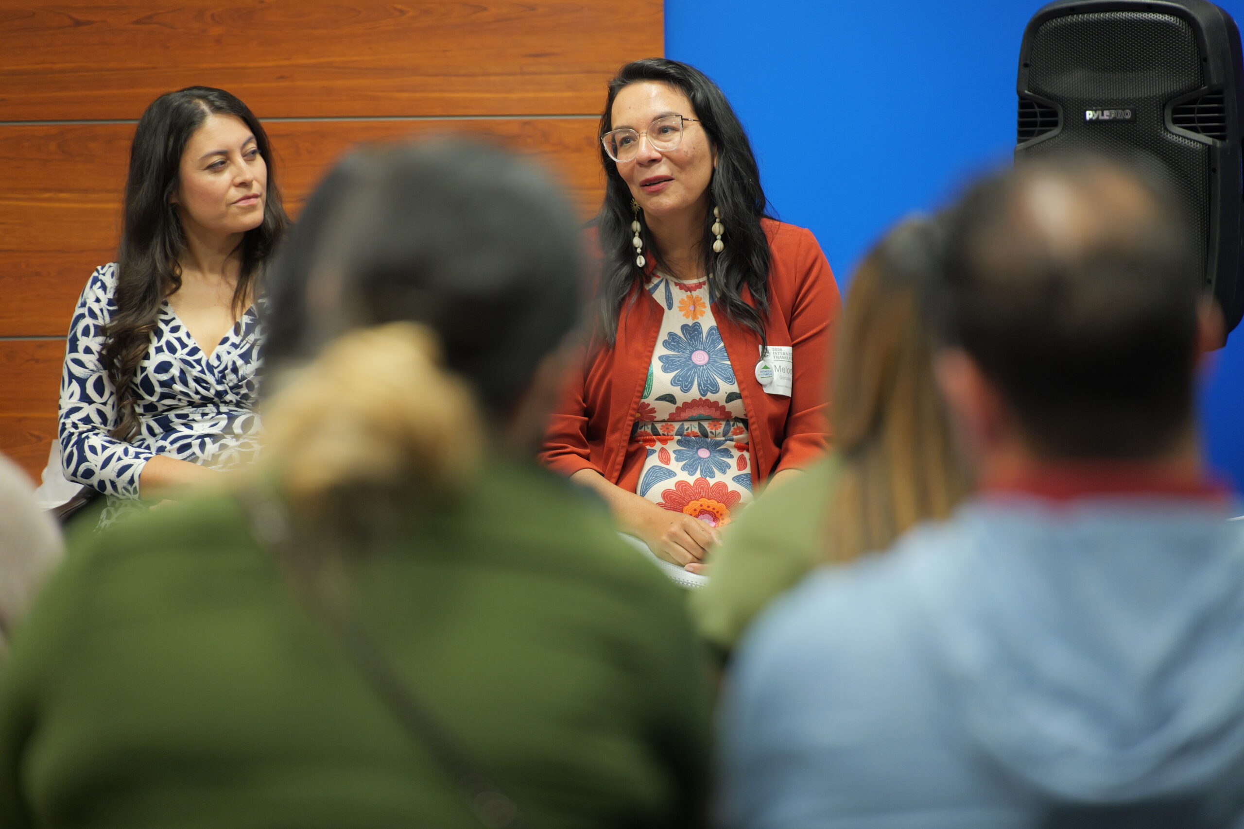 PBS SoCal Digital Producer Carla Pineda, left, listens as interpreter and translator Melody Gonzalez discusses her work adapting Spanish-language educational resources during a panel at the International Translation Day celebration.