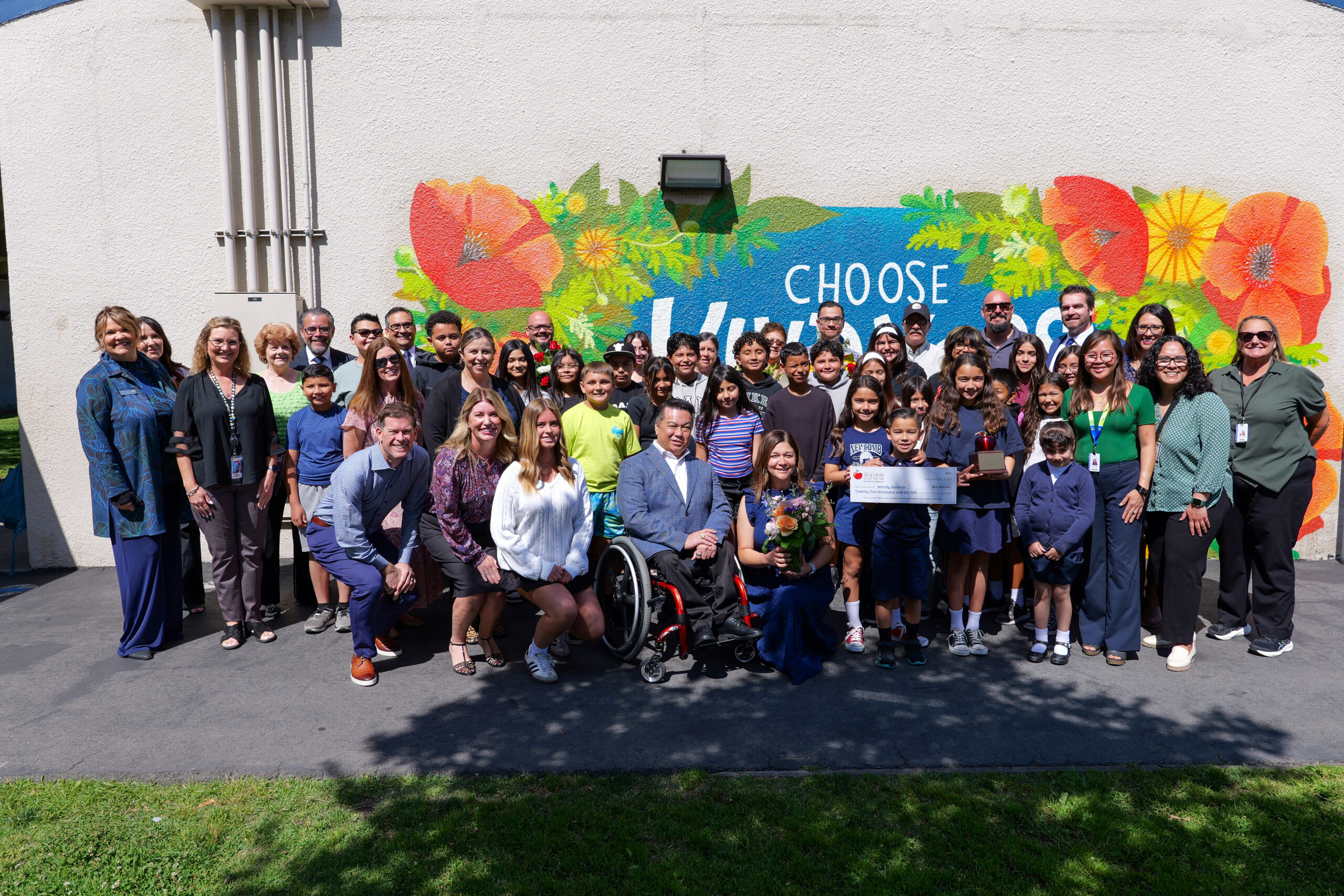Wendy Saldivar, front row, joins students, family members, school and district staff, OCDE representatives and program partners for a group photo outside Loara Elementary School following her surprise Teacher of the Year announcement in April.