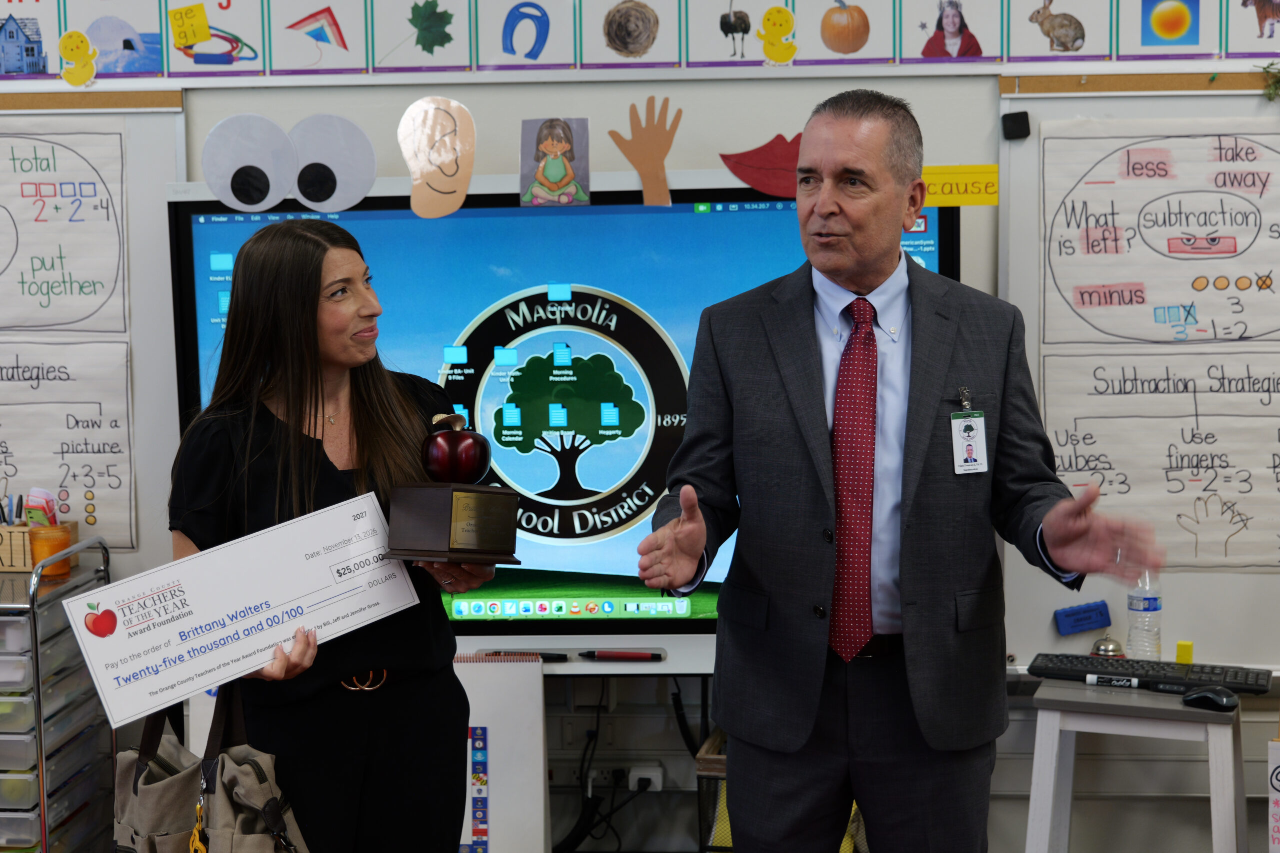 Magnolia School District Superintendent Dr. Frank Donavan congratulates Brittany Walters during the April surprise announcement at Dr. Peter Marshall Elementary School.