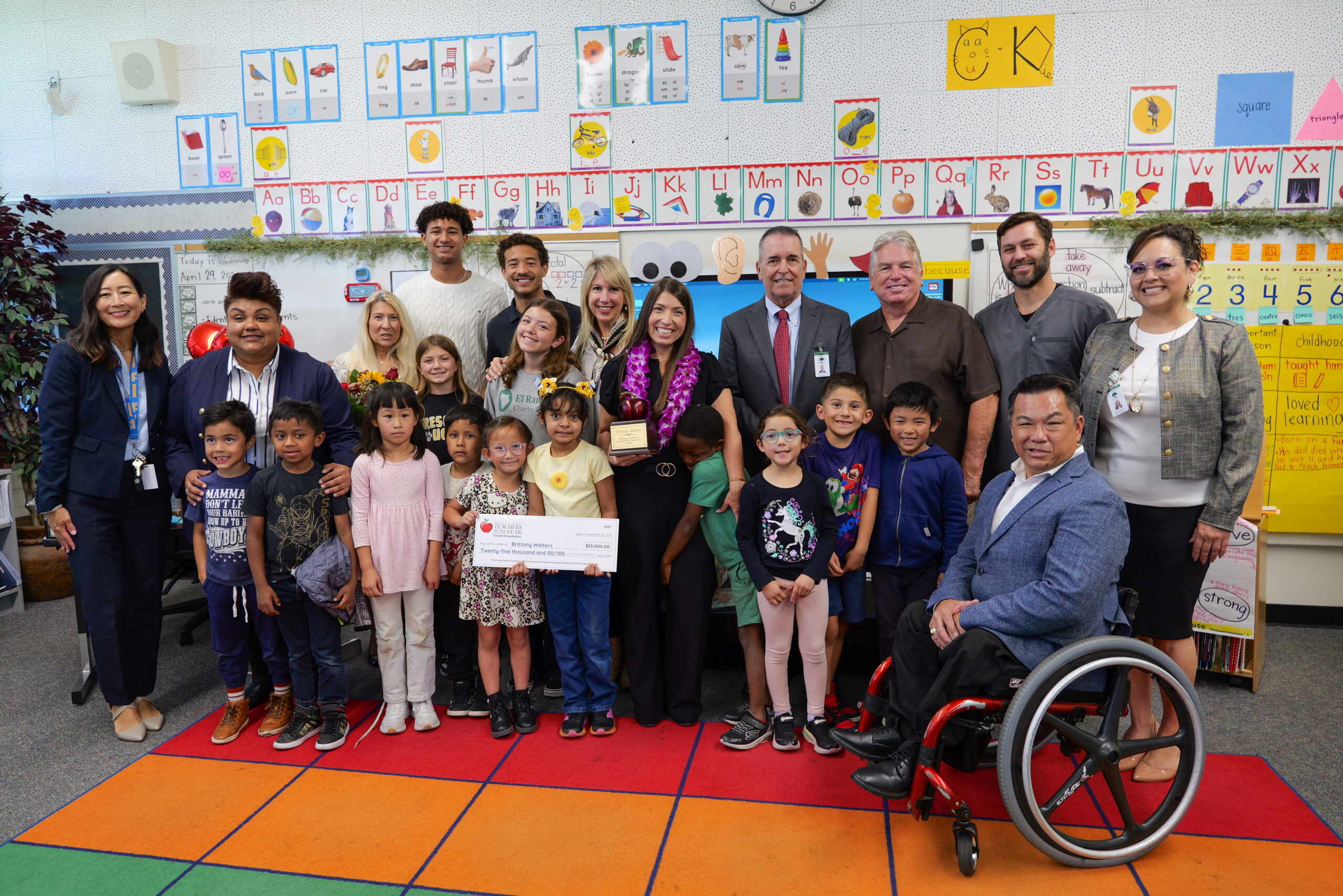 Brittany Walters, center, celebrates with her students, family members, school and district administrators, and Orange County Superintendent of Schools Dr. Stefan Bean following her surprise Teacher of the Year announcement in April.