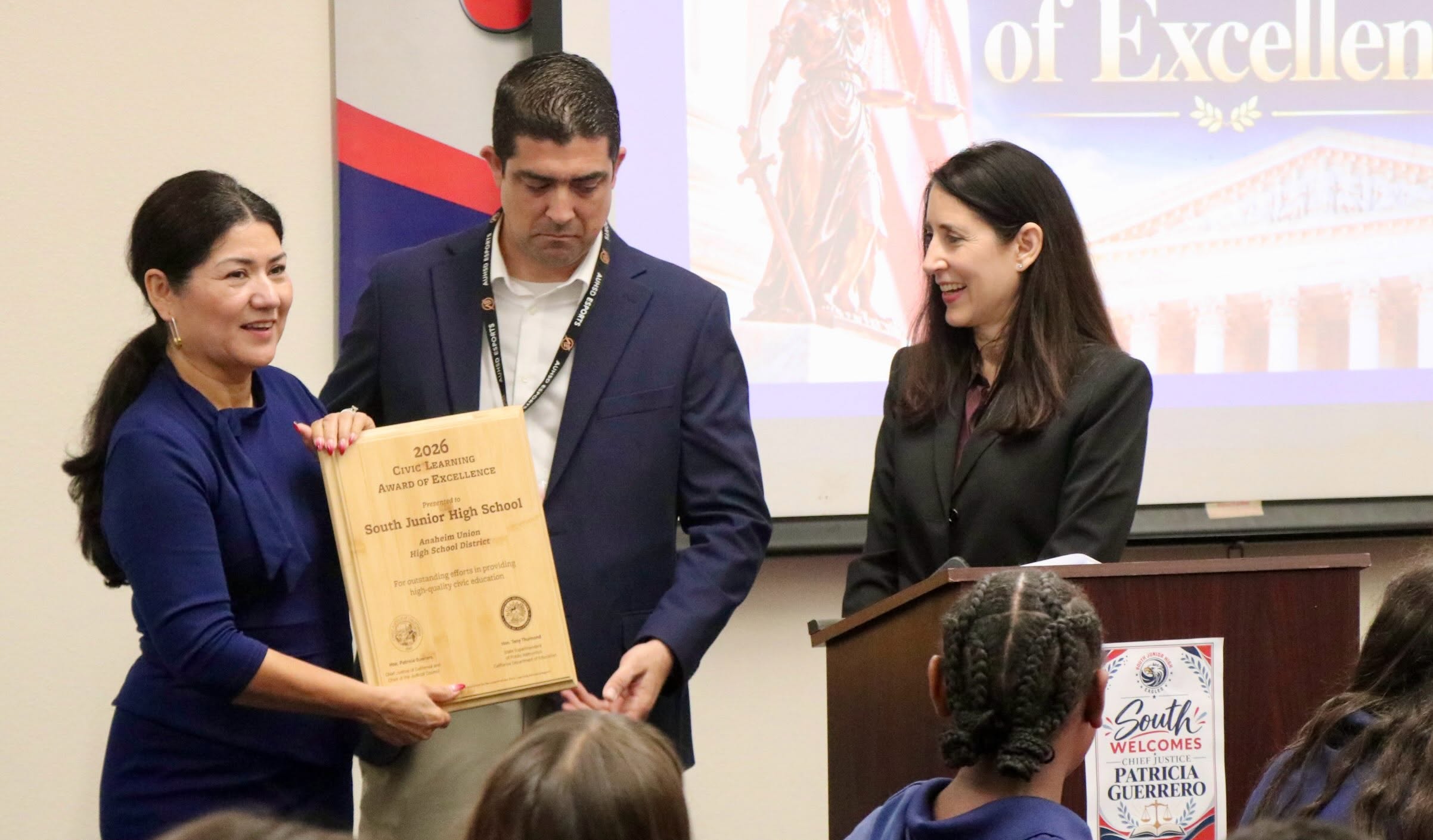 California Chief Justice Patricia Guerrero presents the 2026 State Civic Learning Award of Excellence to South Jr. High Principal Yolanda Mejia and teacher Jason Collar.